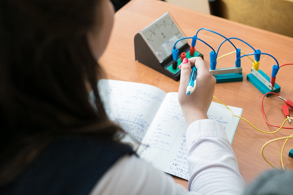 A high school student is working with circuits